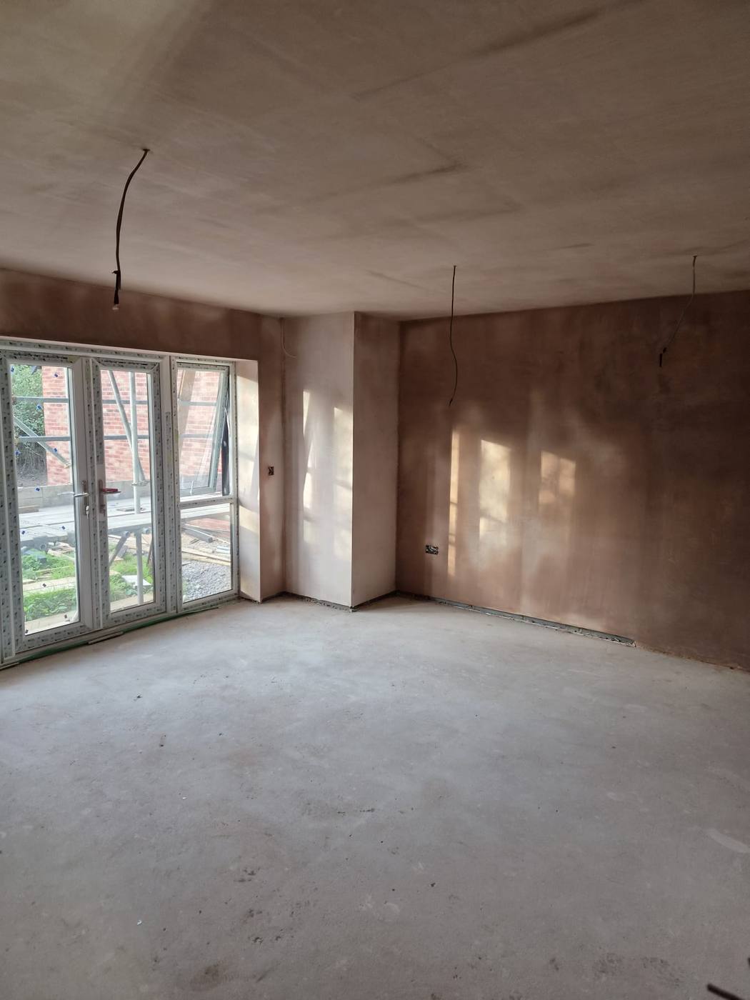 Newly plastered room with french doors
