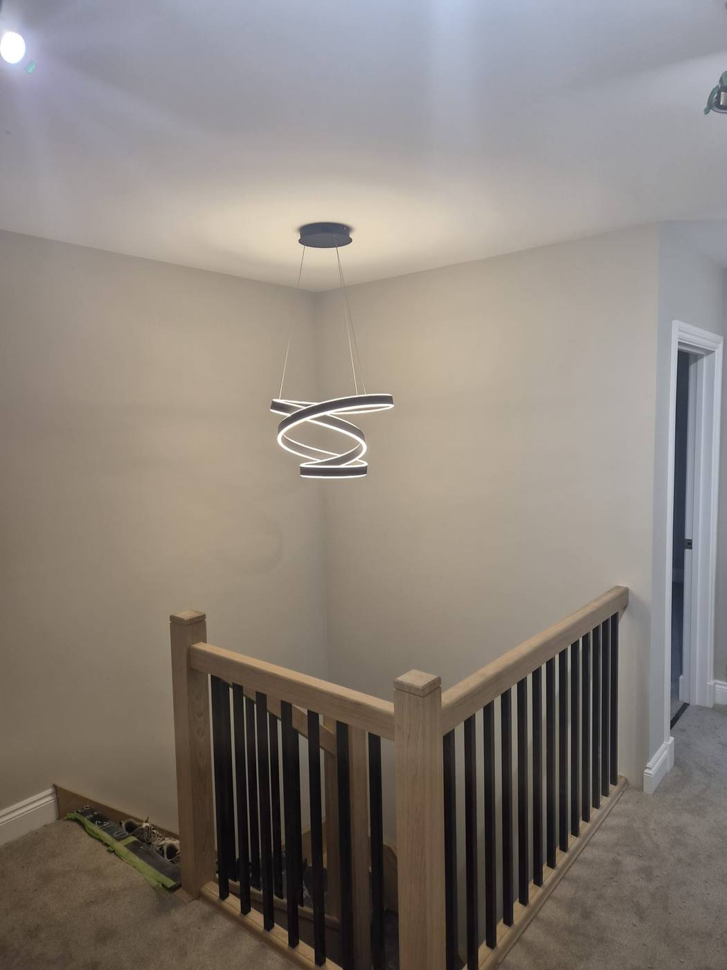 Finished landing with oak balustrade and pendant light